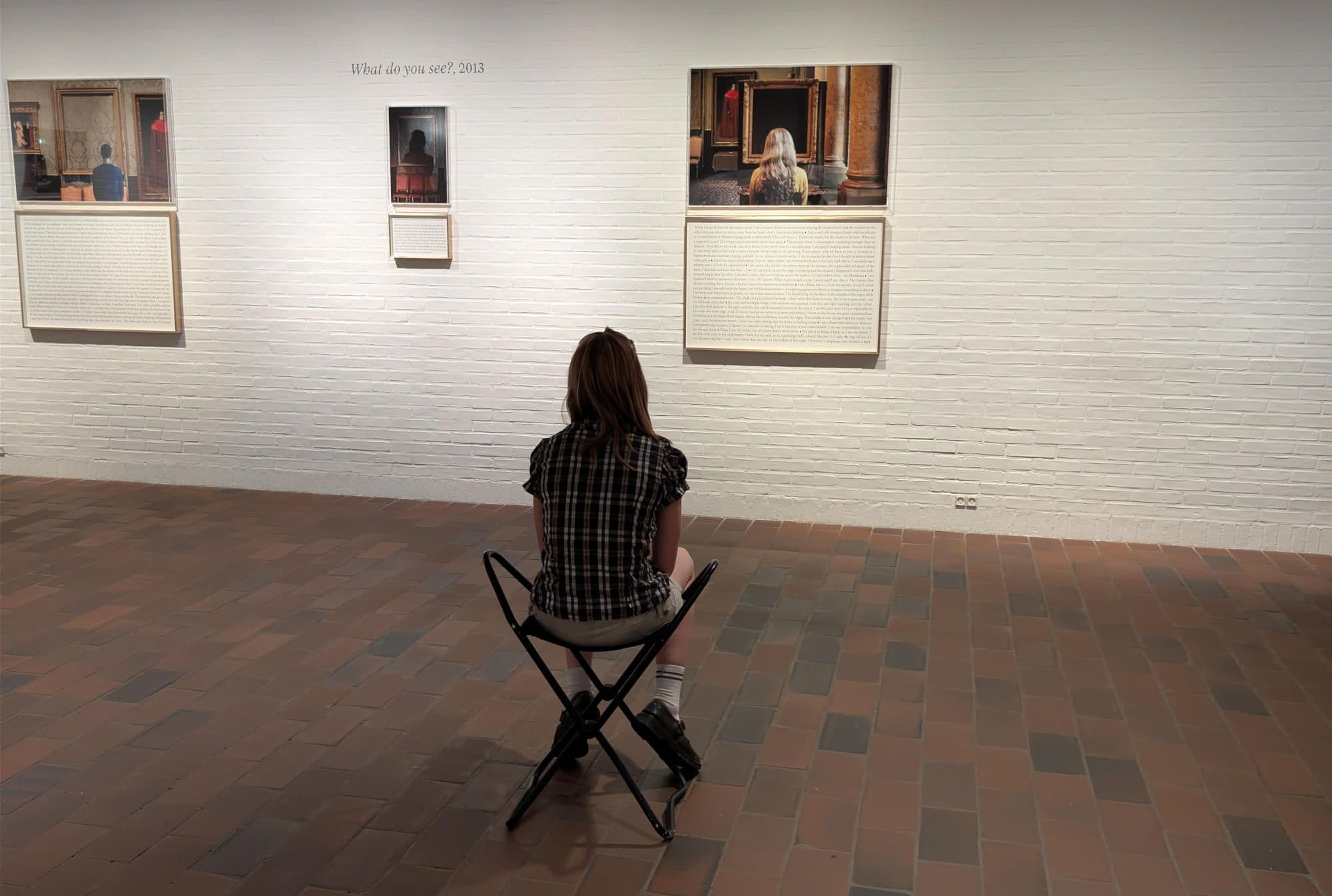 a girl is watching at the art work of shopie calle at the lousiana in cophenhagen